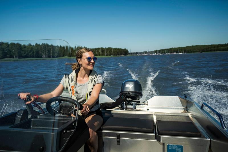 Buster XSr small aluminium family boat with a young lady driving